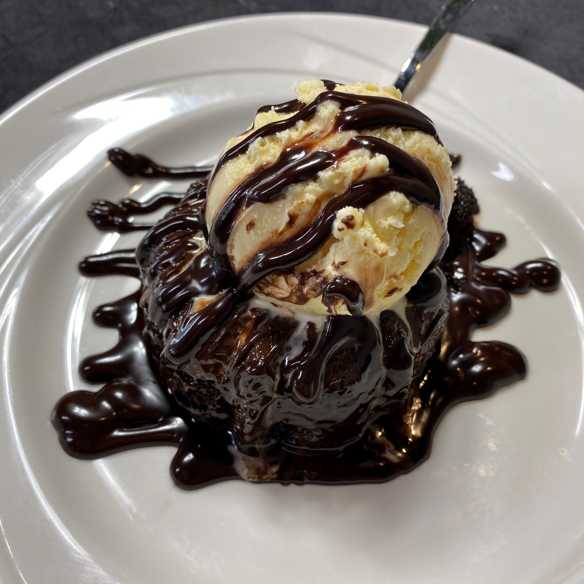 A chocolate lava cake a la mode drizzled with chocolate sauce served at The Hill Tavern Bar & Grill at Galloping Hill Golf Course in Kenilworth, NJ.