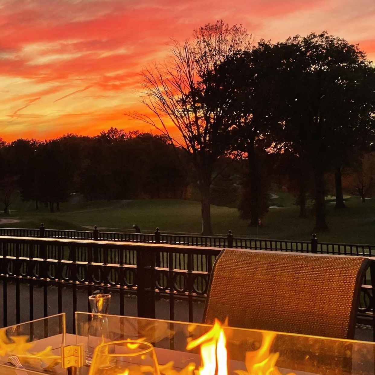 A lit firepit overlooking the sunset view at The Hill Tavern Bar & Grill at Galloping Hill Golf Course in Kenilworth, NJ.